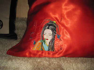 geisha with small butterfly embroidered on pillow