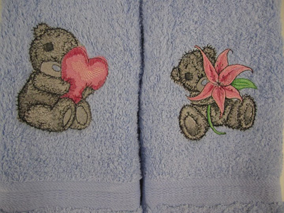 two towels embroidered with teddy bear designs