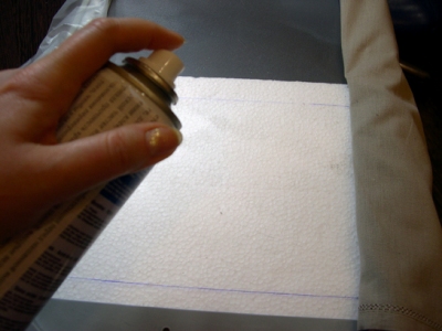 Spraying the glue on the fabric