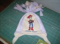 knitted hat with toy story woody embroidery design. Download woody and sew.